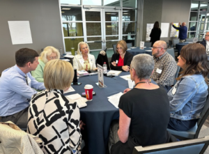 people talking at a conference round table